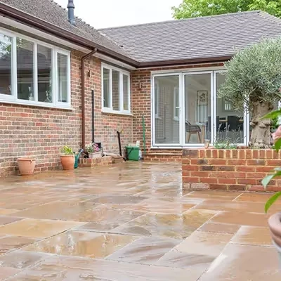 wet tiled patio with house in background