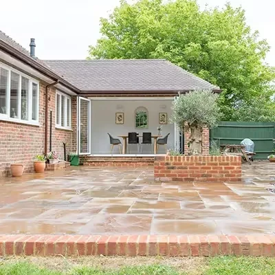 orange tiled wall with open faced dining area